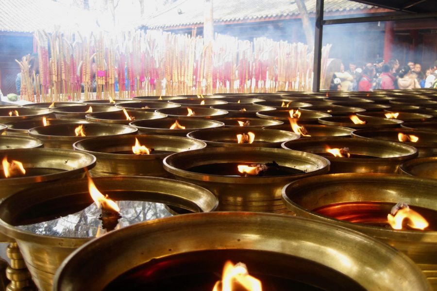 Burning oil candles at a temple in Jinan, China. ©KettiWilhelm2014