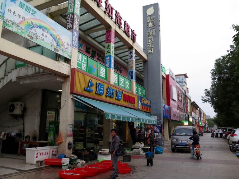 A row of shops and a polluted sky across the street from my apartment where I live in Suzhou, China. ©KettiWilhelm2015