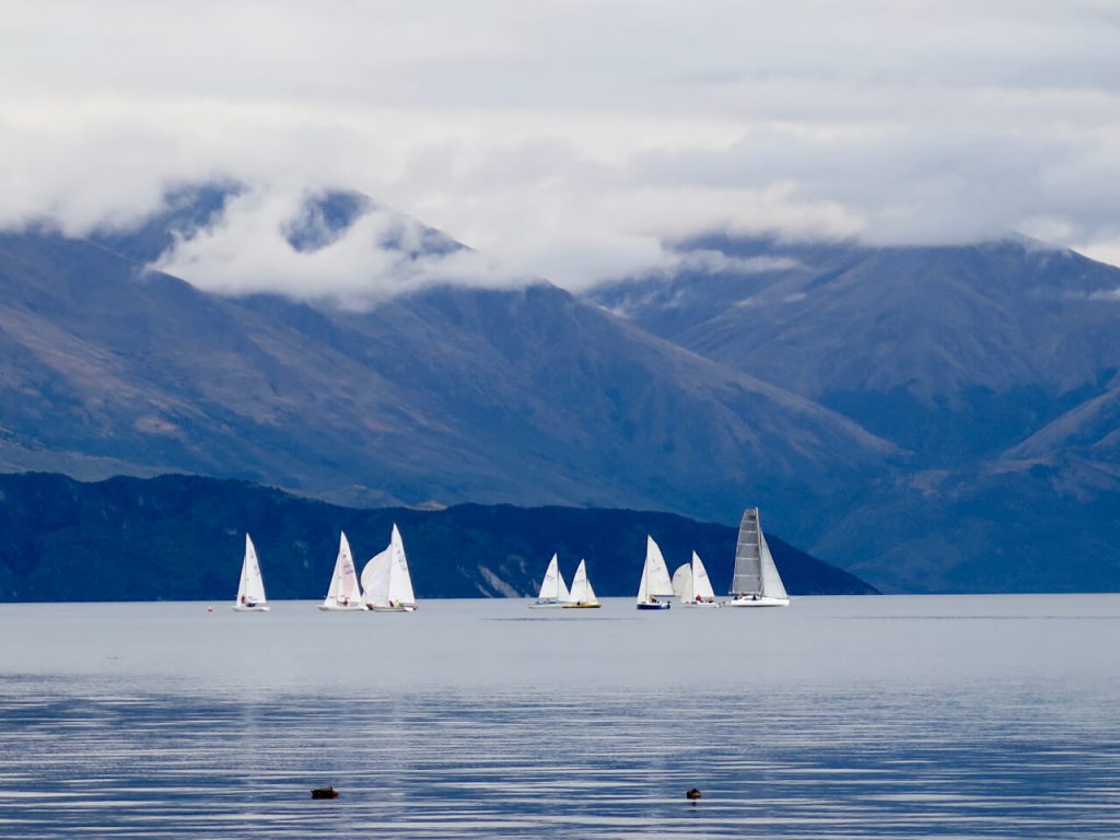 White sailboats and blue mountains on Lake Wanaka, South Island of New Zealand. ©KettiWilhelm2016