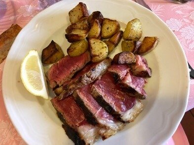 Bistecca alla Fiorentina, or Floretine Steak, a traditional menu item from Tuscany, cooked in an oven and served rare. ©KettiWilhelm2016