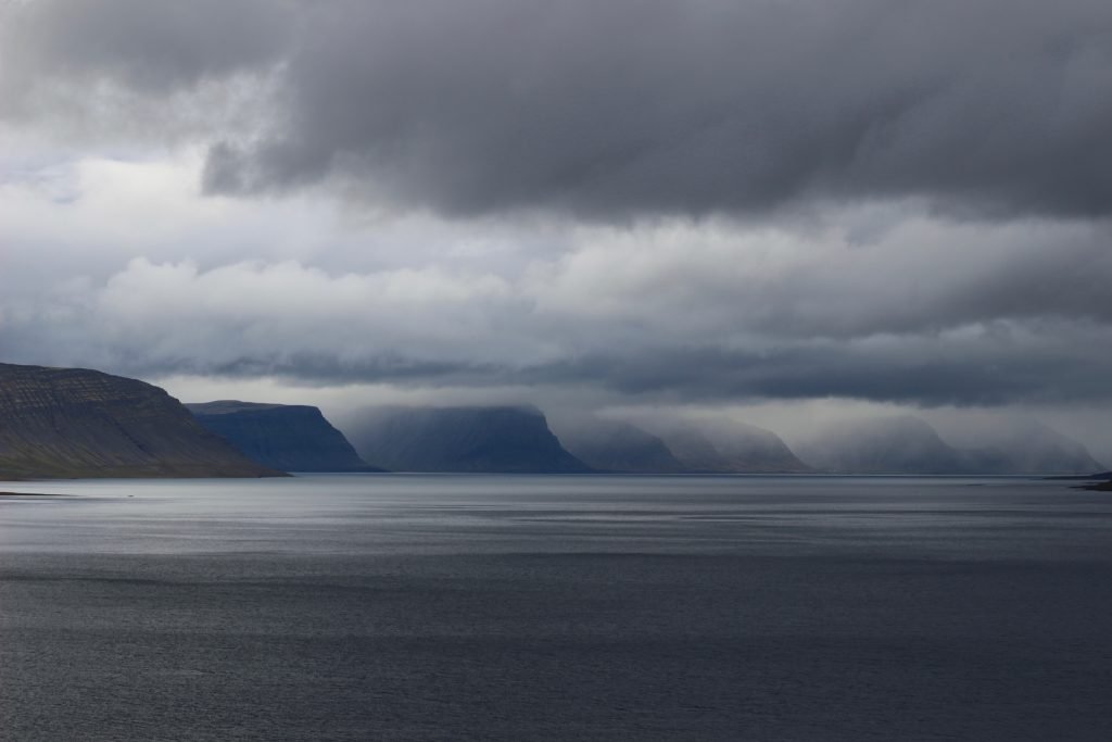 Dark layered clouds over a row of mountains over a bay in Western Iceland. ©KettiWilhelm2018