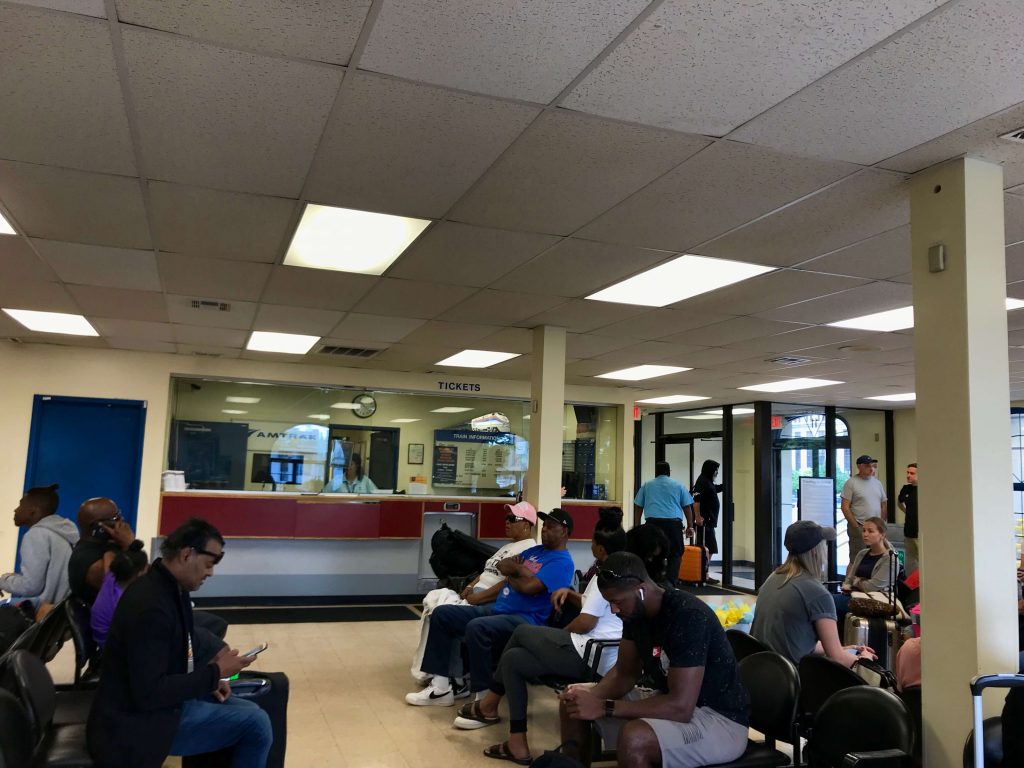 Passengers waiting in the tiny waiting room inside the Detroit Amtrak train station on West Baltimore Avenue. ©KettiWilhelm2019