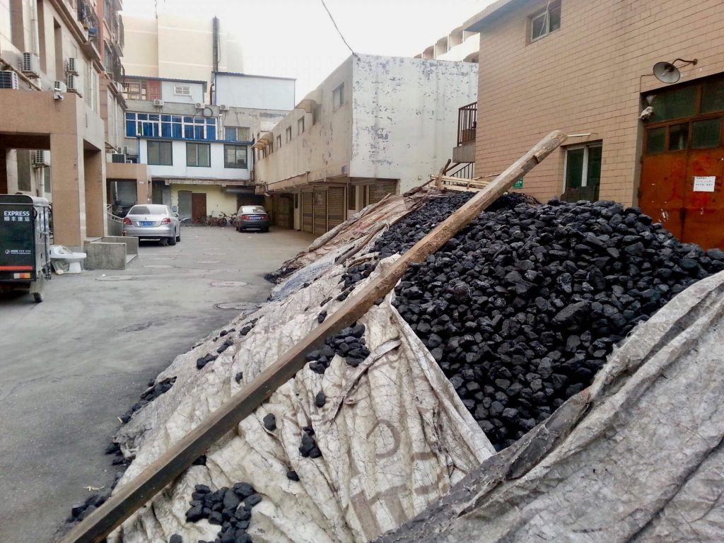 A pile of coal to be burned for heating outside an apartment building in Jinan, China. ©KettiWilhelm2014