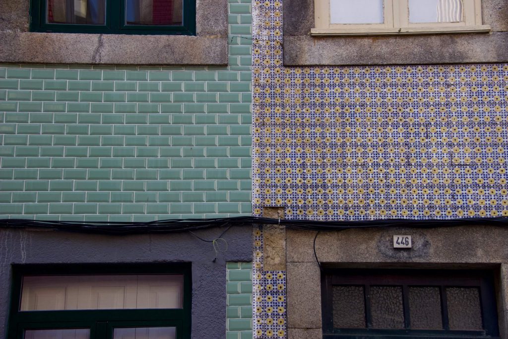 Colorful blue, green, and floral tiled buildings in Porto, Portugal. ©KettiWilhelm2020