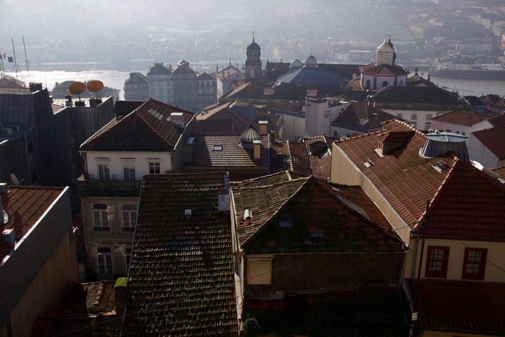 Mossy rooftops and fog over the Douro River in Porto, Portugal. ©KettiWilhelm2020