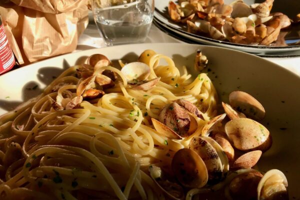 A plate of spaghetti con vongole (spaghetti with fresh clams) in Naples, Italy. ©KettiWilhelm2020