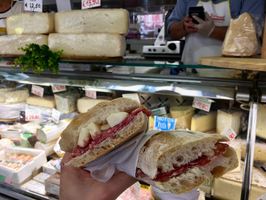 Simple cheese and salami Italian sandwiches in front of my favorite cheese stall at the market in Milan. ©KettiWilhelm2020