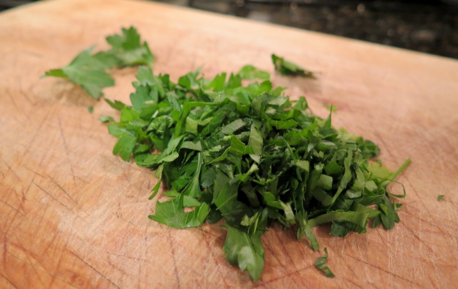 Chopped up Italian parsley on a cutting board. ©KettiWilhelm2020