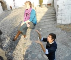 Sitting on a stone wall in Granada, Spain, wearing really cool boots.