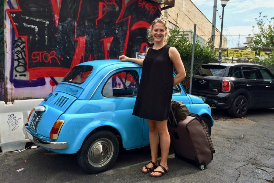 Standing in front of a small blue car in Rome, after moving to Italy to continue my expat travel blog. ©KettiWilhelm2016