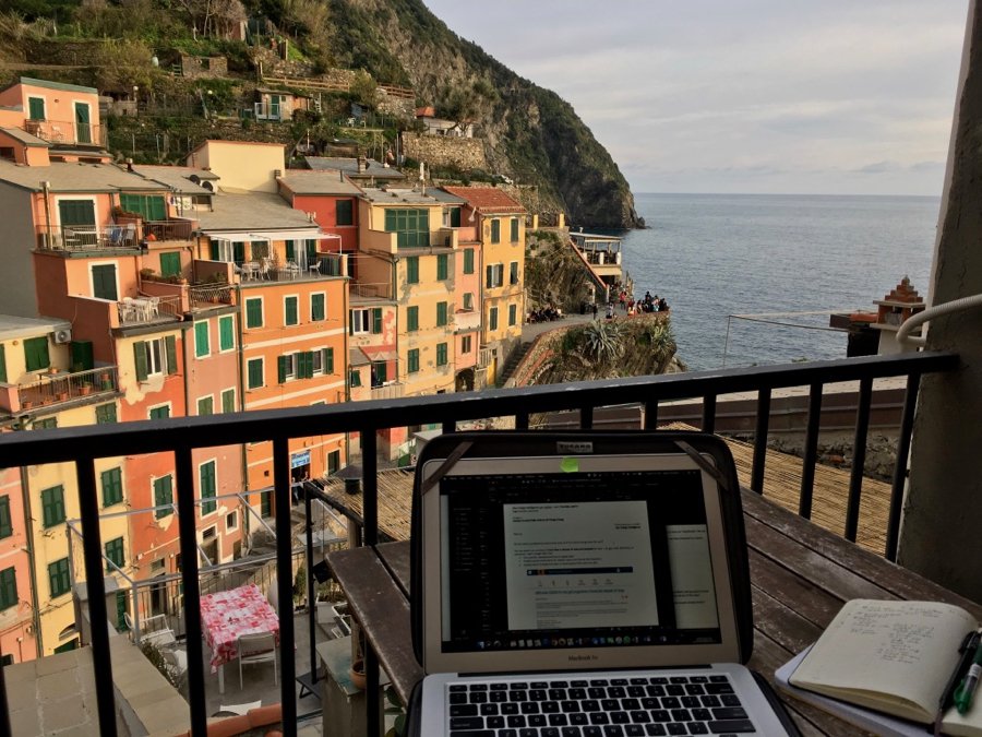 Working on my travel blog on my balcony overlooking the colorful houses of Riomaggiore, Italy. ©KettiWilhelm2020