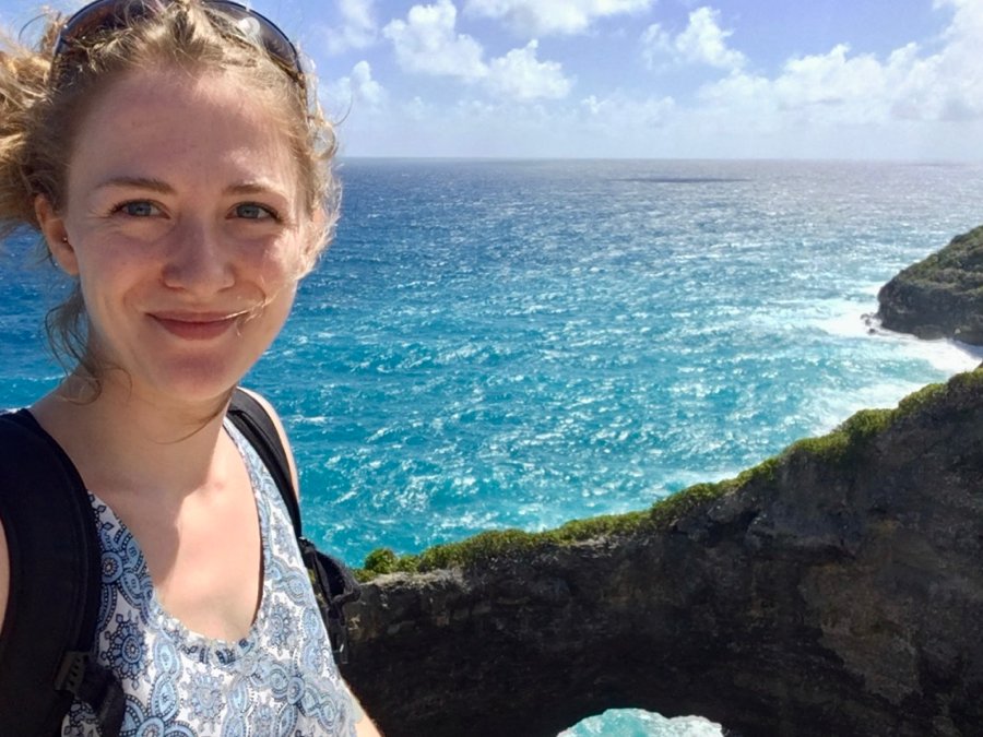 That’s me (the author, Ketti Wilhelm) smiling in front of a cliff that drops off into the bright, turquoise Caribbean on a sunny day. (During one of many ways that I found of moving abroad – by getting a job abroad as a guide.) ©KettiWilhelm2020