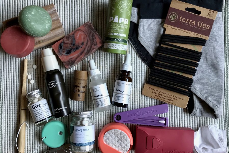 My zero-waste toiletry routine (including glass bottled products from DECIEM, a brand that has a TerraCycle recycling program, and many plastic-free options) sitting on a light green cloth. ©KettiWilhelm2021