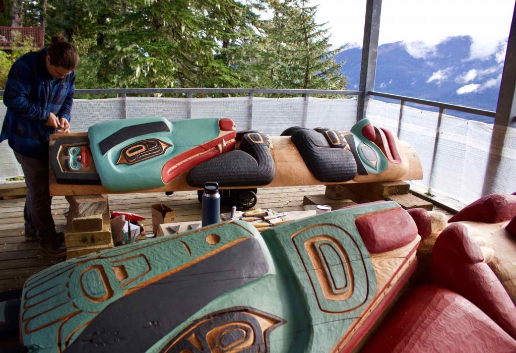 A man carving a totem pole at the top of Mt. Roberts, in Juneau, Alaska. ©KettiWilhelm2021