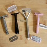 All four sustainable shaving options in this review. Left to right, on a wooden background: Albatross safety razor, Leaf Shave's Twig razor, Leaf's original safety razor alternative, and Well Kept. ©KettiWilhelm2021