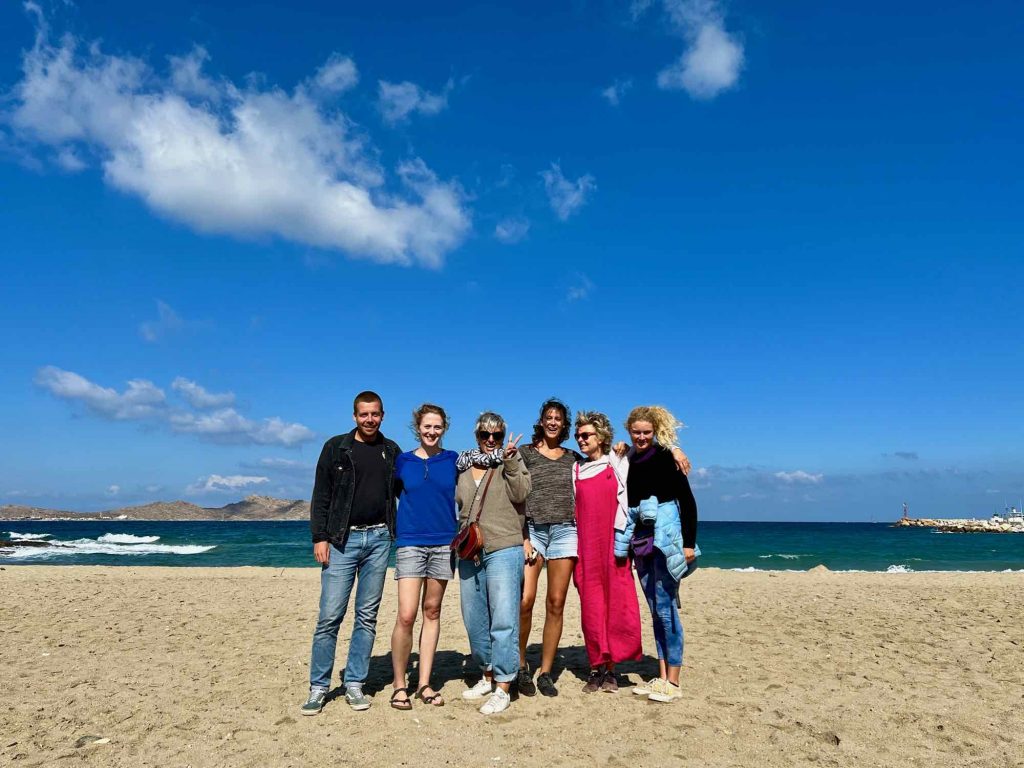 A group photo of the author with the local members of Clean Blue Paros on Piperi Beach, in the town of Naousa on Paros, after cleaning up and counting the plastic and other garbage from the beach. ©KettiWilhelm2021