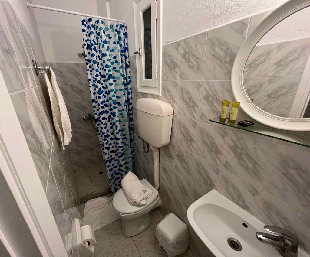 A very small bathroom in the Aliki Panorama Hotel, one of the accommodations reviewed in this Paros travel guide. ©KettiWilhelm2022