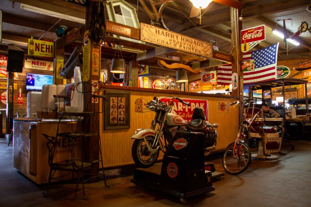 Kitschy vintage signs and a toy Harley Davidson motorcycle decorate the inside of the authentic, country Southern restaurant Airport Grocery in Cleveland, Mississippi. ©KettiWilhelm2022