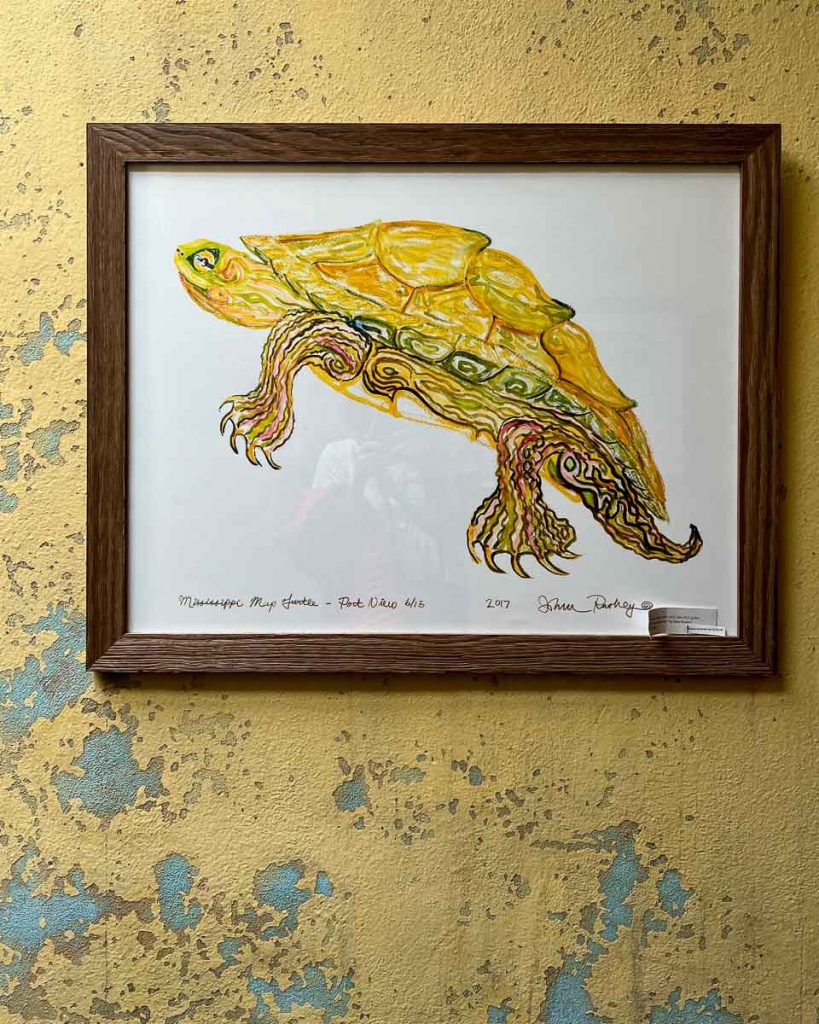 Local art on display at the Travelers Hotel in Clarksdale, Mississippi. (A drawing of a turtle in bright yellows by John Ruskey.) ©KettiWilhelm2022