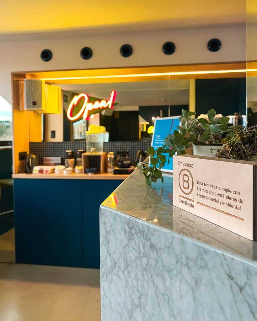 A sign in the rooftop coffee shop at the Sleep'N Atocha hotel says that it is the first Certified B Corp lodging in Spain. ©KettiWilhelm2023