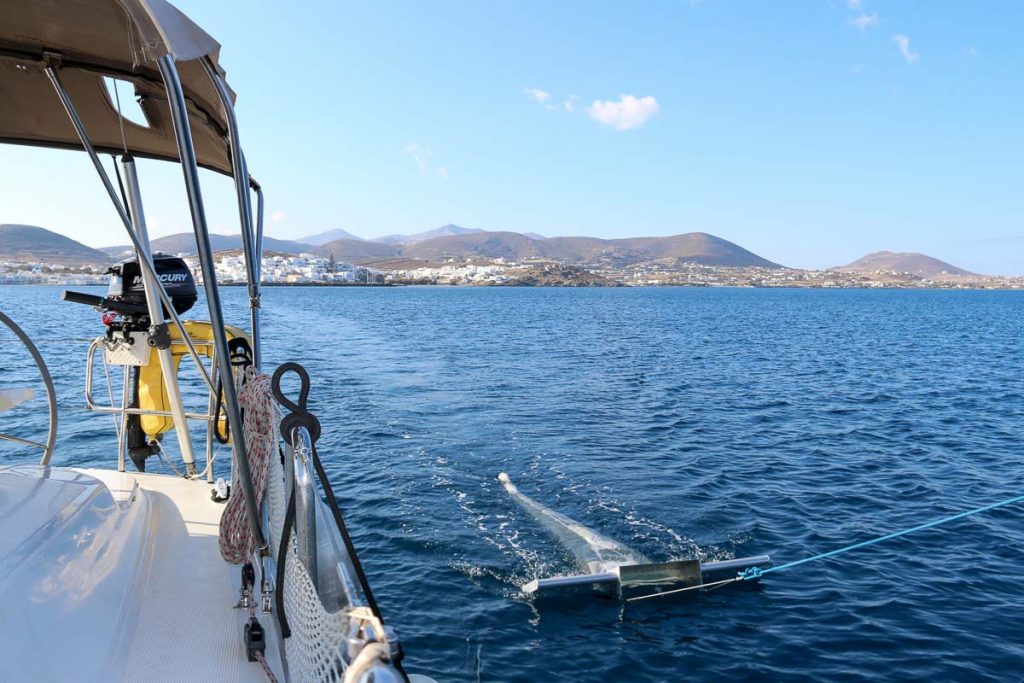 The trawler, used for collecting water samples to test for microplastics pollution, dragging in the water behind the sailboat. ©KettiWilhelm2022