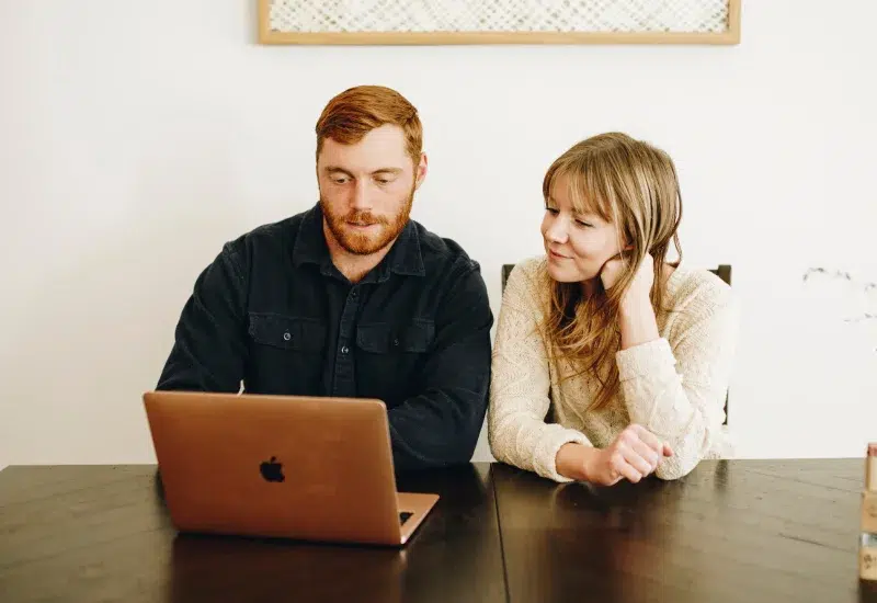 Founders of The Earthling Co, a sustainable small business based in Reno, Nevada, looking at their computer screen.