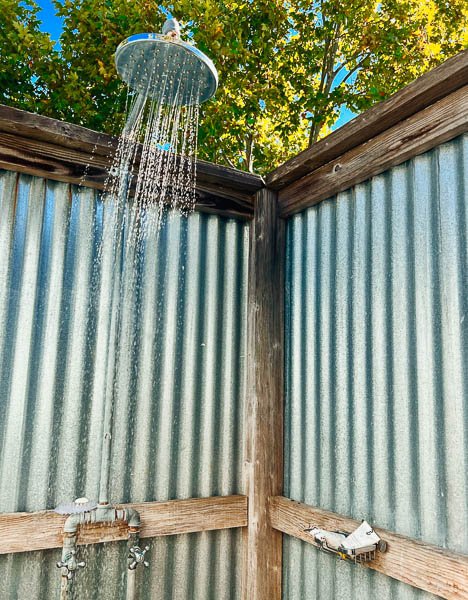 Everist shampoo and conditioner in aluminum tubes sitting on the shelf of an outdoor shower at an eco-friendly resort in Napa Valley, California. ©KettiWilhelm2022