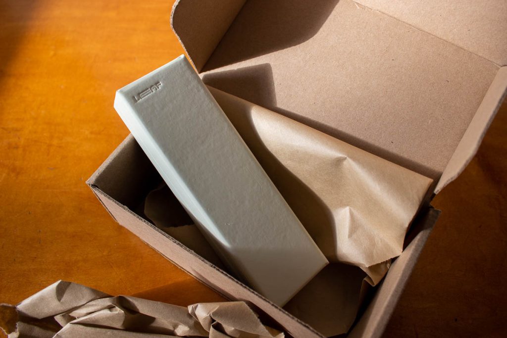 Plastic-free packaging from Leaf Shave Co. containing their at-home dermaplaning tool. The packaging is entirely recyclable brown paper and cardboard. ©KettiWilhelm2023