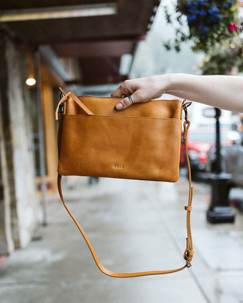 A leather purse from ABLE Clothing brand, a sustainable and ethically made fashion brand.