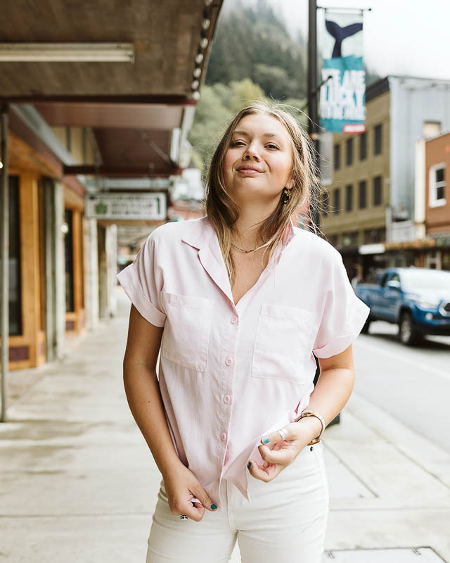 Resolute Boutique owner Cordova Pleasants wearing a pink button-down top from Bella Dahl in front of her Juneau, Alaska, boutique.