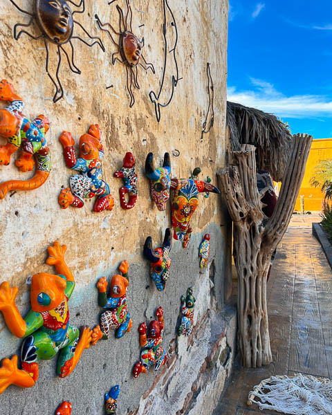Colorful, ceramic frogs for sale hanging on a wall in Loreto, Baja California. ©KettiWilhelm2023