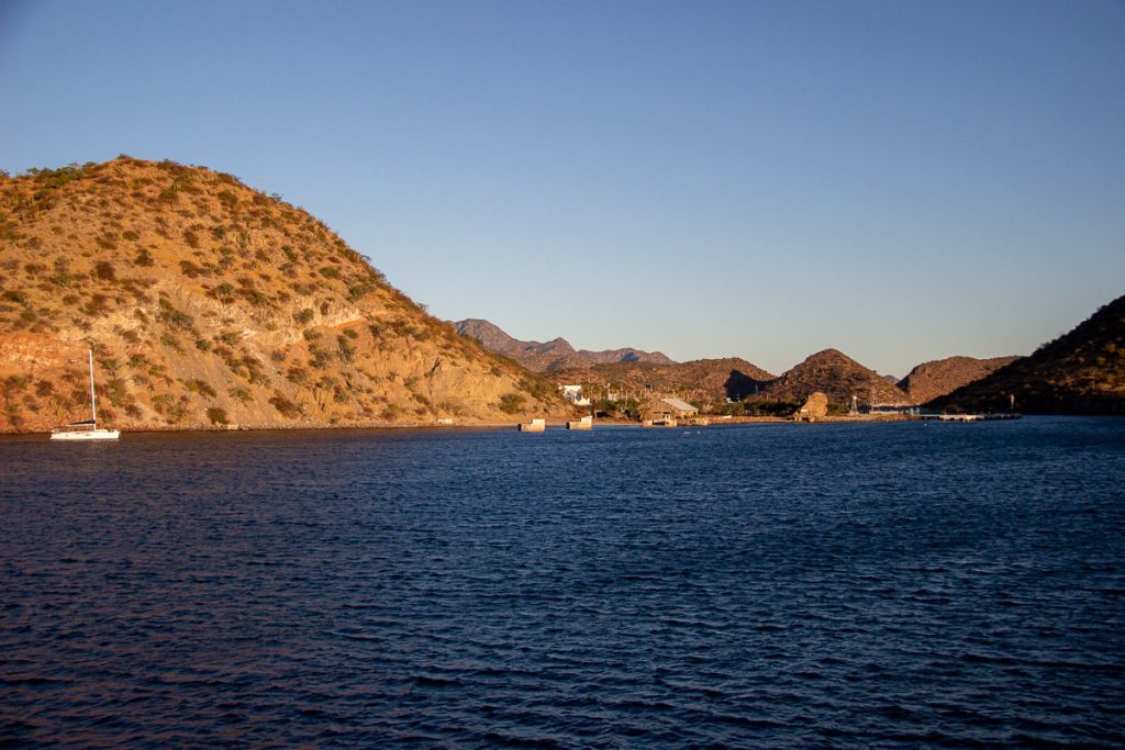 Morning light warms up the dry desert hills around the tiny port town of Puerto Escondido, Baja California Sur, Mexico, as seen from UnCruise’s small ship the Safari Voyager. ©KettiWilhelm2023