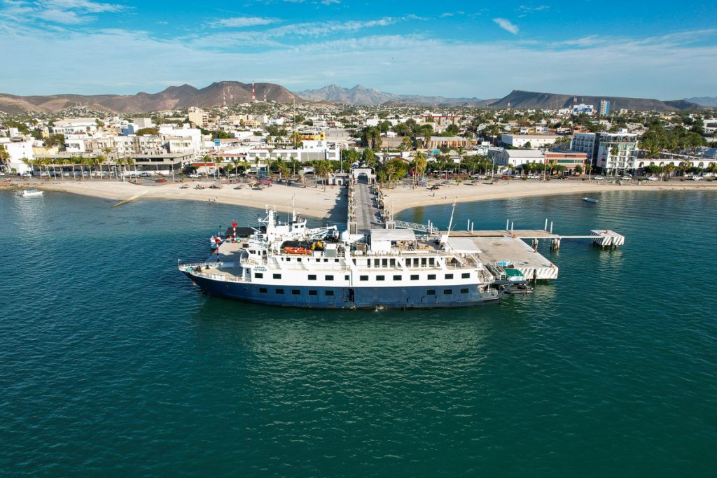 UnCruise's small cruise ship the Safari Voyager docked in front of the town of La Paz, preparing for the UnCruise Baja adventure trip. ©KettiWilhelm2023