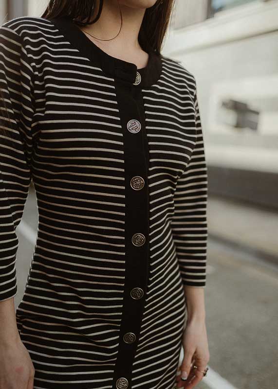 Curated vintage sustainable clothing from Unus Wear in Juneau, Alaska – owner Serena sports a black and white striped vintage dress.
