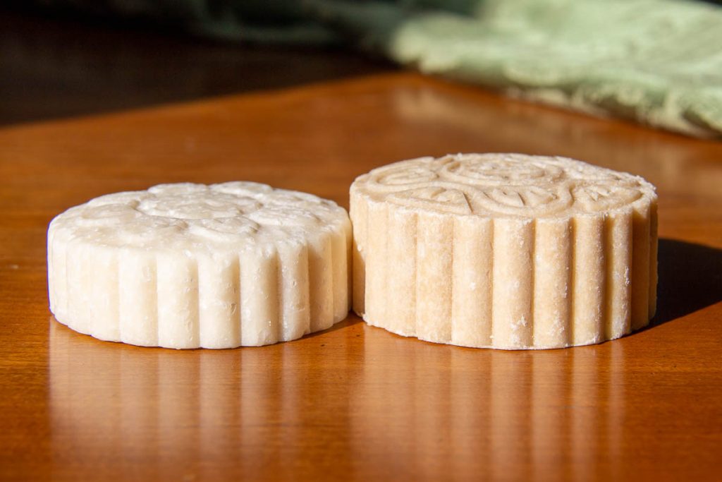 Two of my Viori rice shampoo bars, both similar shades of natural beige. One is much smaller, after about three weeks of use, the other is brand new, showing how long Viori shampoo bars last. ©KettiWilhelm2023