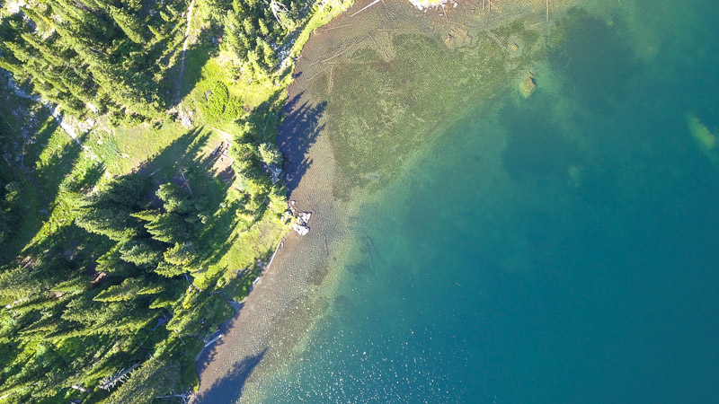 An aerial view of a lake and forest in northwest Montana. ©KettiWilhelm2023