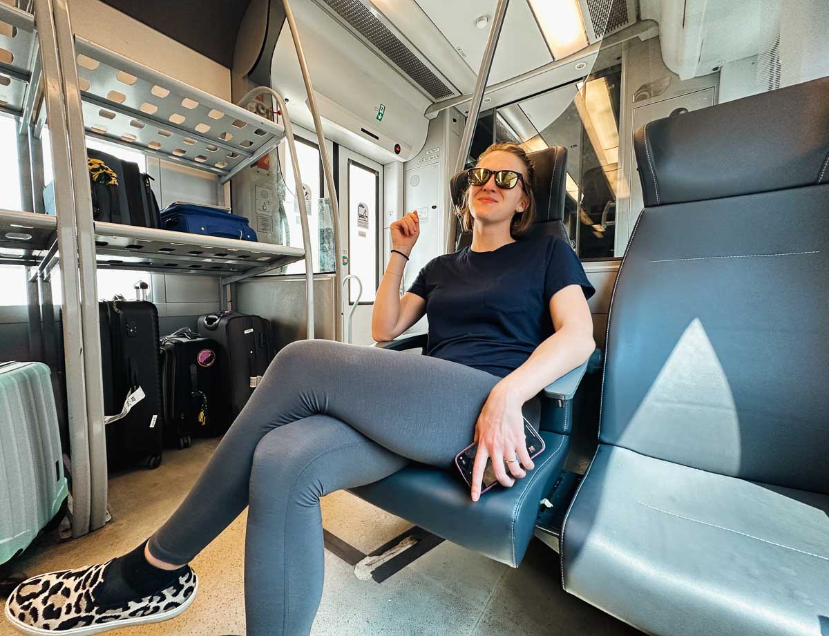 Ketti Wilhelm, the travel blogger and author of this guide to buying train tickets in Europe, riding a train in Milan, Italy. ©KettiWilhelm2023