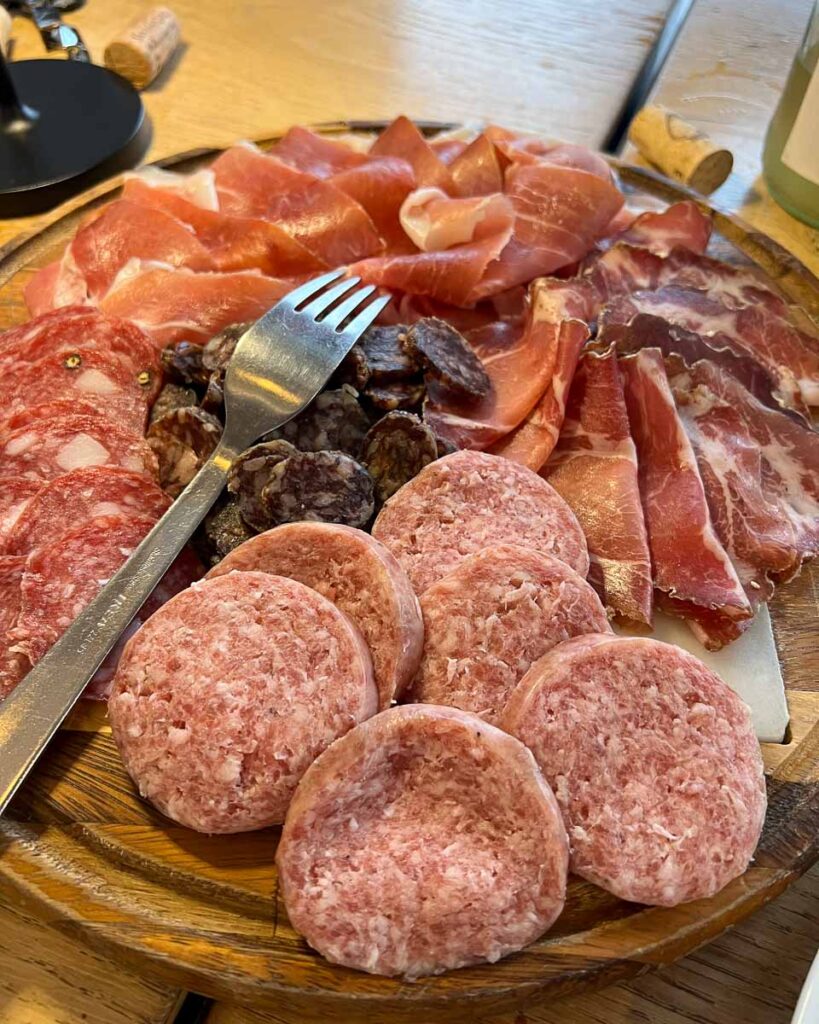 Locally made Italian charcuterie board, including local specialty "ciausculo" at the organic and biodynamic winery Tenuta San Marcello. ©KettiWilhelm2023