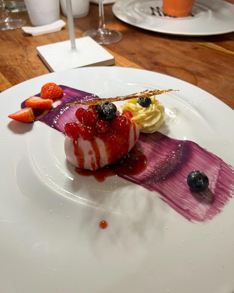 Beautiful bright purple sauce smeared under an Italian fruit dessert in Sirolo, Marche. ©KettiWilhelm2023