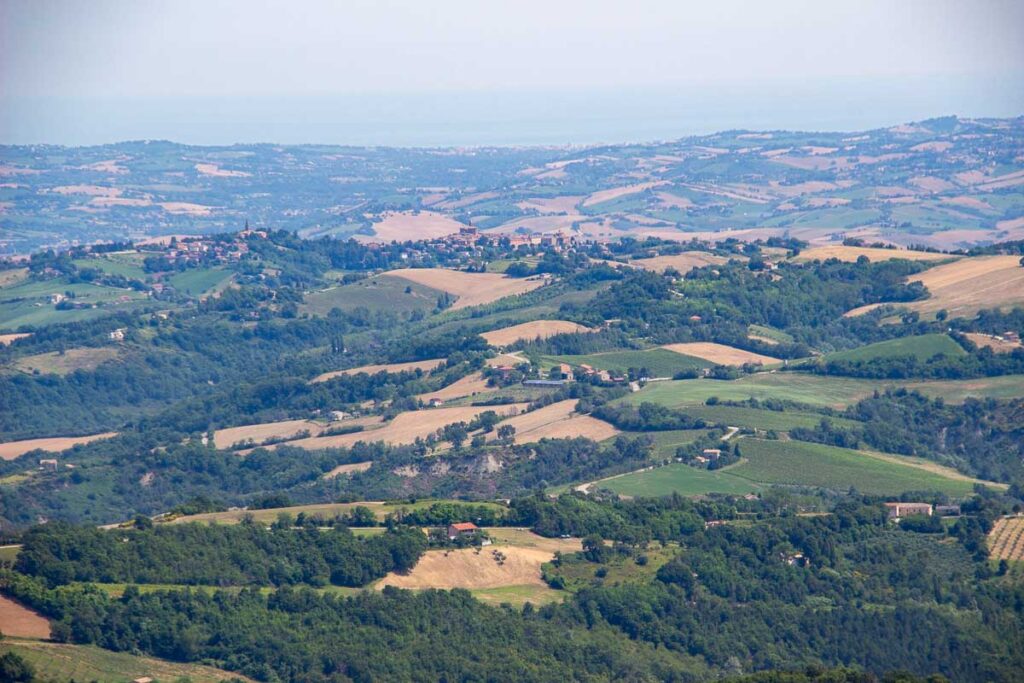 Rolling hills of farm fields and white road, or "strade biache" in Italian as seen from a high overlook that we rode our ebikes to on this tour in March, Italy. ©KettiWilhelm2023