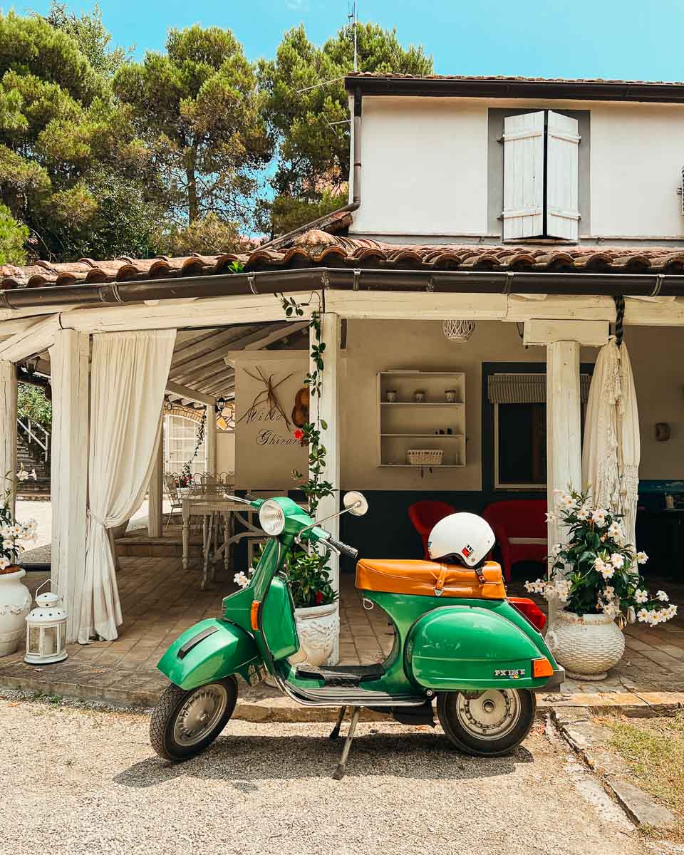 A vintage green Vespa scooter parked outside our hotel at the end of our bike tour in rural Italy. ©KettiWilhelm2023