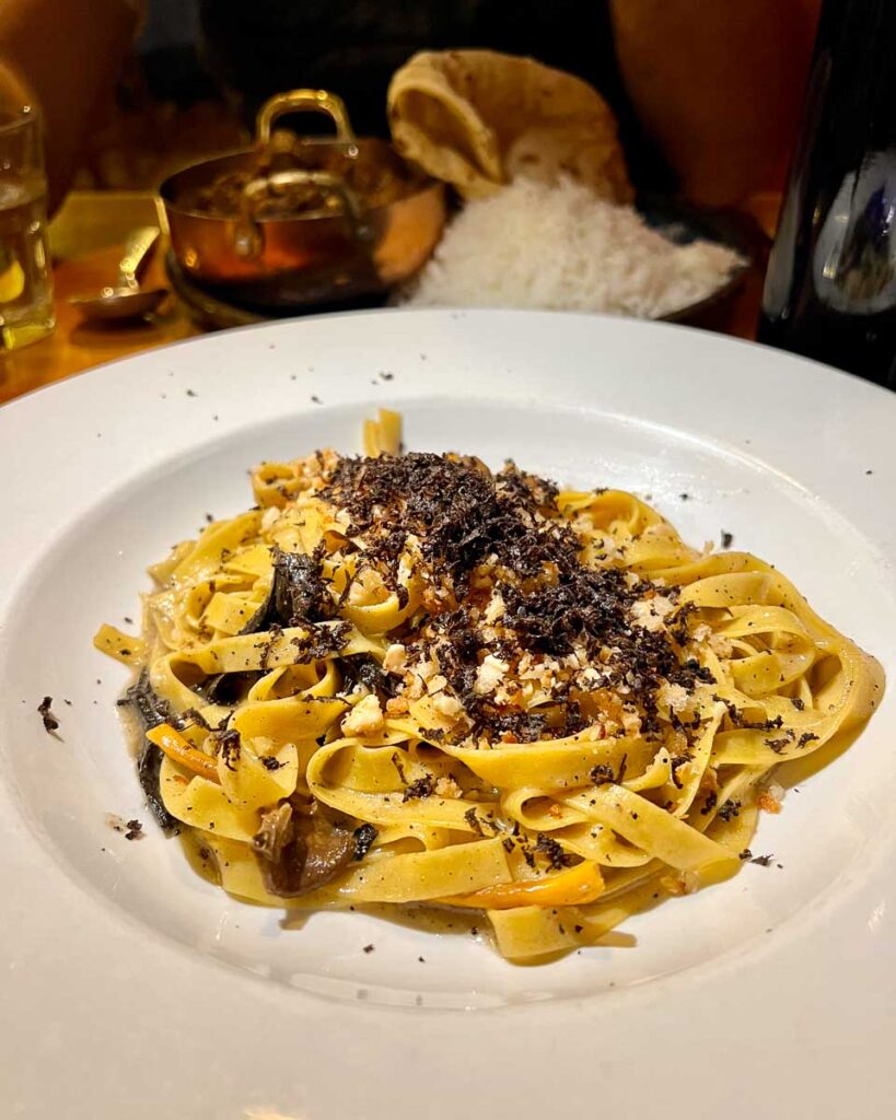 A plate of Italian pasta with locally foraged mushrooms at Fiddlehead Bistro, one of the best restaurants in the Adirondacks and a top-notch example of local farm-to-table dining. ©KettiWilhelm2023