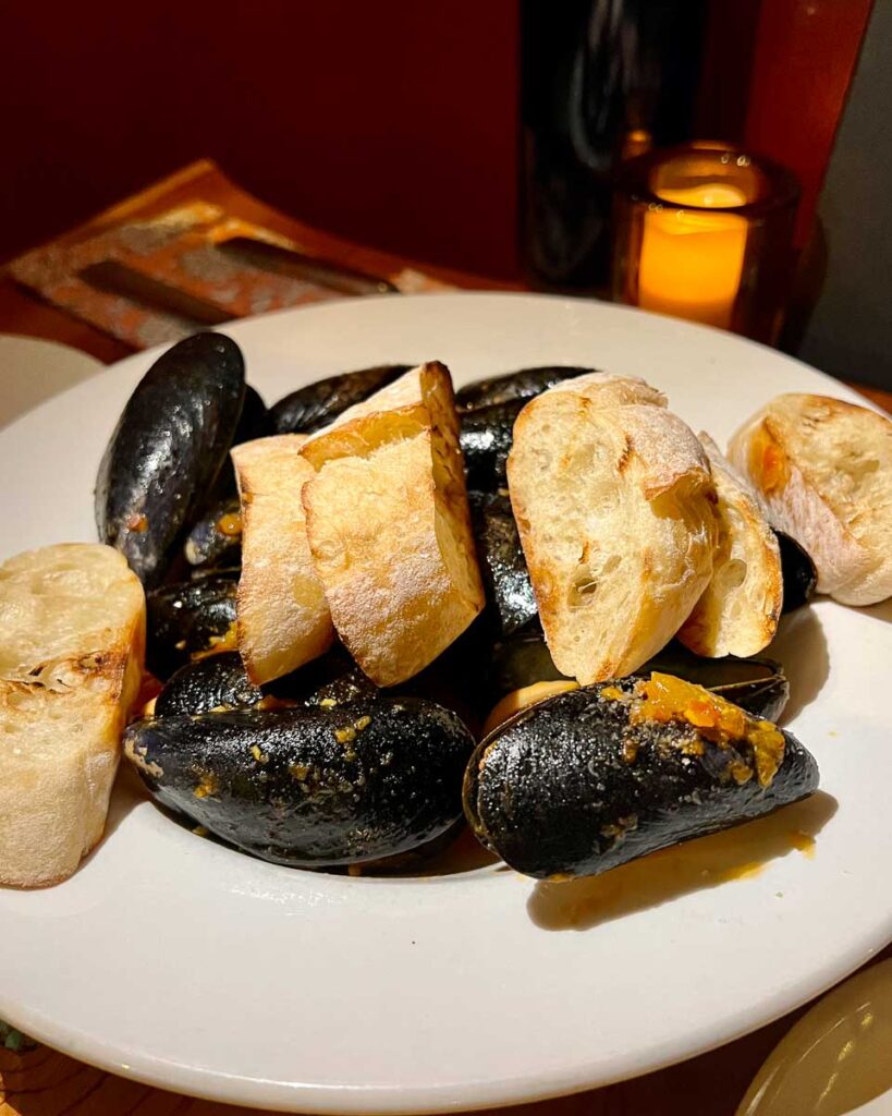 A plate of mussels from Maine at Fiddlehead Bistro, one of the best restaurants in the Adirondacks and a top-notch example of farm-to-table dining. ©KettiWilhelm2023