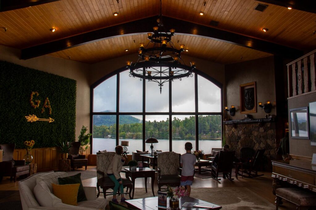 The recently renovated lobby of the Golden Arrow hotel in Lake Placid shows picture windows looking out straight onto Mirror Lake. ©KettiWilhelm2023