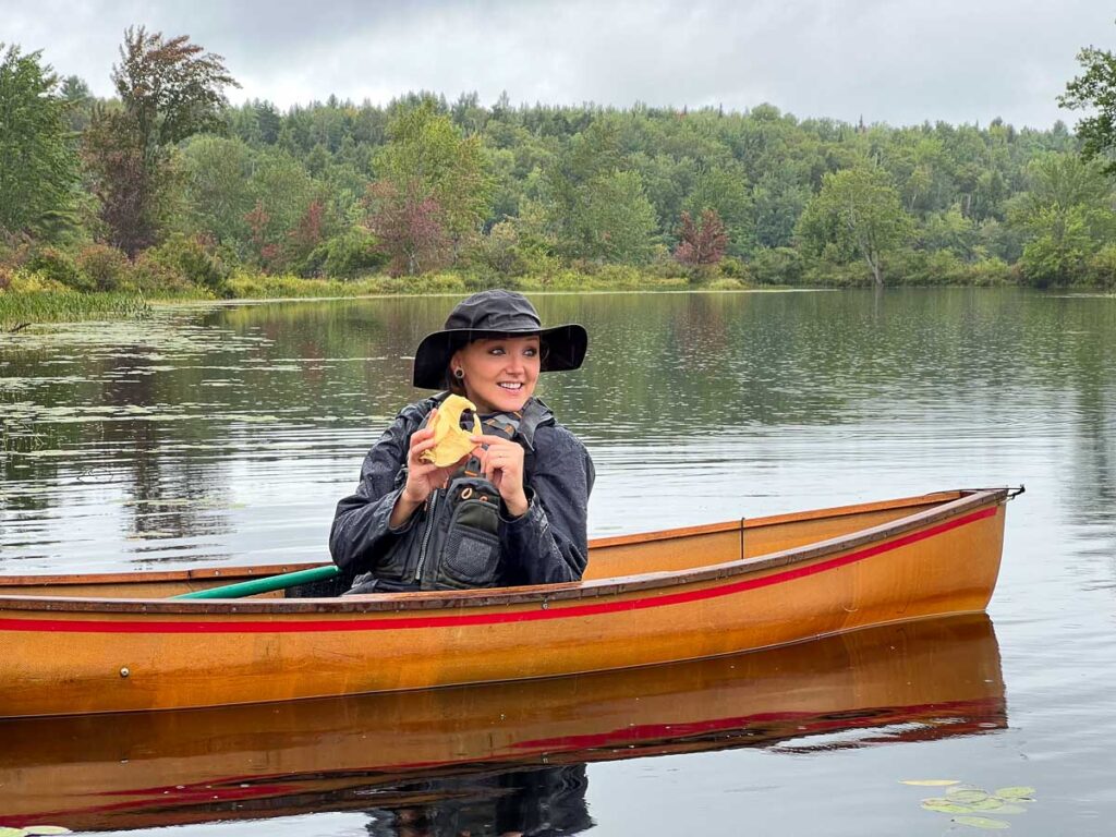 Our expert guide, Nicole, points out the animals of the Adirondacks during our Raquette River guided canoe trip at The Wild Center. ©KettiWilhelm2023