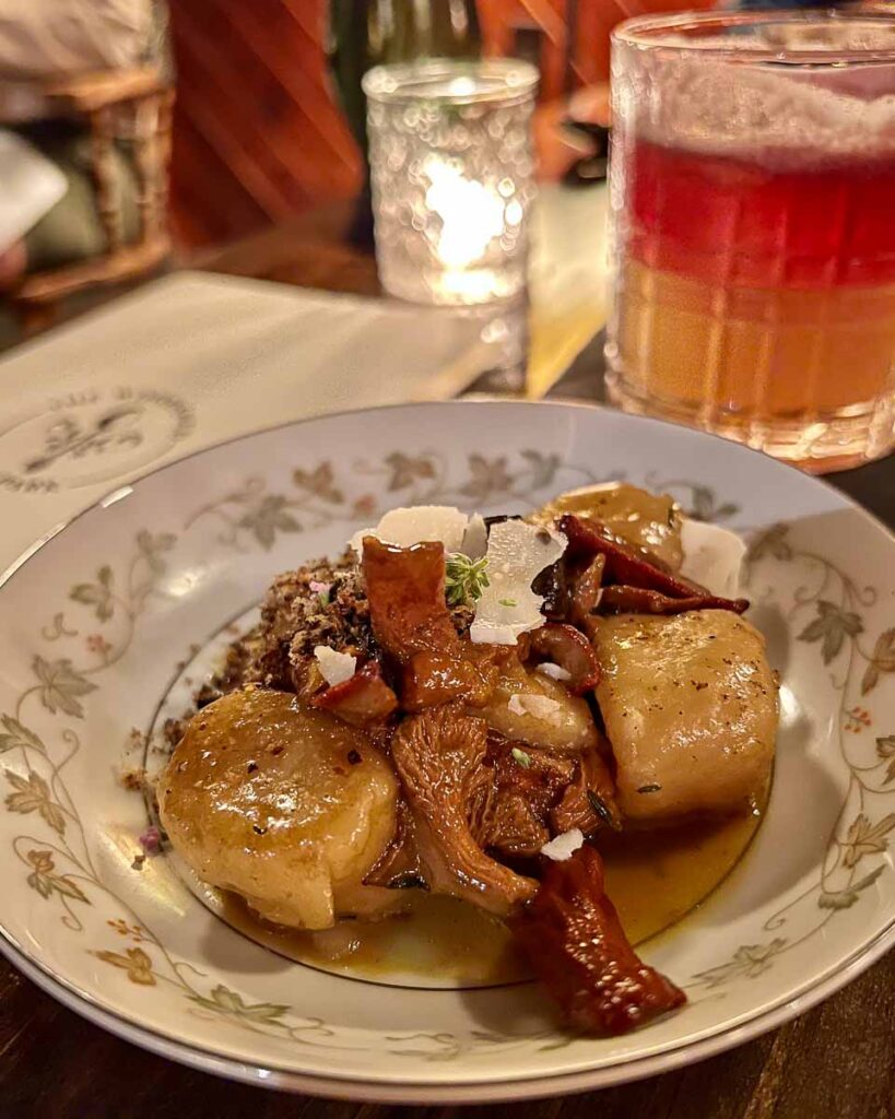 A plate of “gnudi,” a rare kind of Italian pasta similar to gnocchi, with locally foraged mushrooms at Woodshed on Park, one of the best new restaurants in the Adirondacks ©KettiWilhelm2023