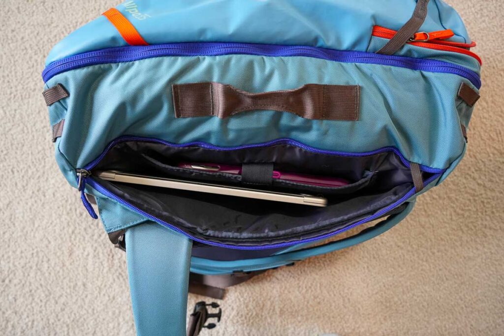 The separate, padded laptop compartment on the Cotopaxi Allpa fits a laptop and tablet, but the laptop doesn’t fit inside the backpack’s smaller and safer pocket. ©KettiWilhelm2023