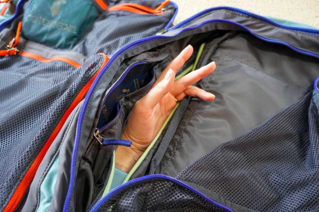 Demonstrating access to the interior pocket of the Cotopaxi Allpa 35l pack directly from the outside, with the reviewer’s hand sticking into the main compartment – not a good anti-theft feature for a travel backpack. ©KettiWilhelm2023