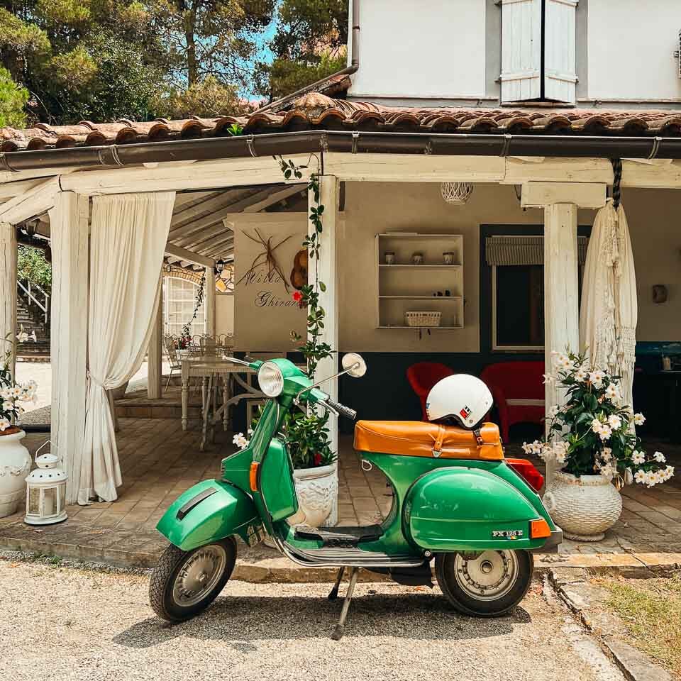 A vintage green Vespa scooter parked outside our hotel at the end of our bike tour in rural Italy. ©KettiWilhelm2023