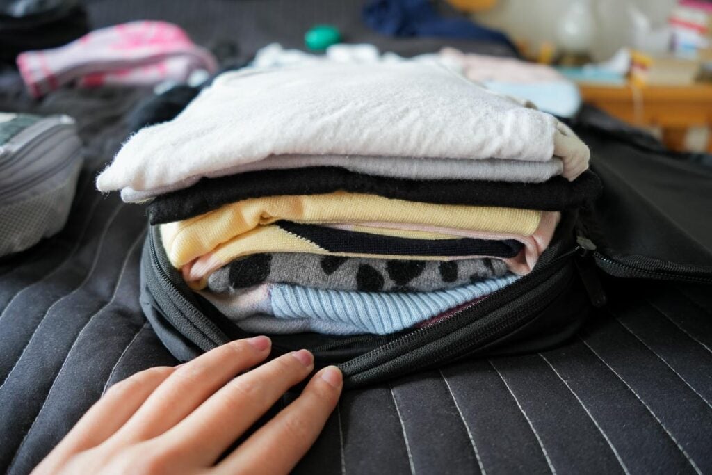 Tortuga compression packing cube filled with six tops, including three sweaters. ©KettiWilhelm2024